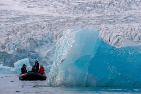 Dinghy with tourists in front of the glacier edge of Monacobreen, iceberg, Liefdefjord, Woodfjord