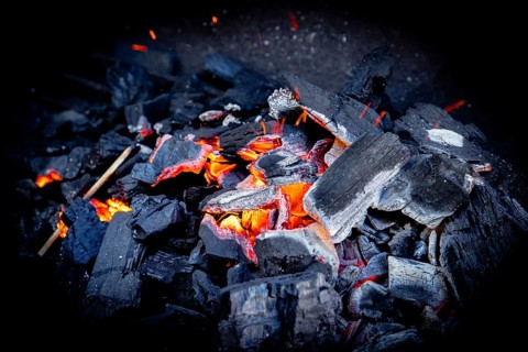Close-up of glowing charcoal with glowing sparks