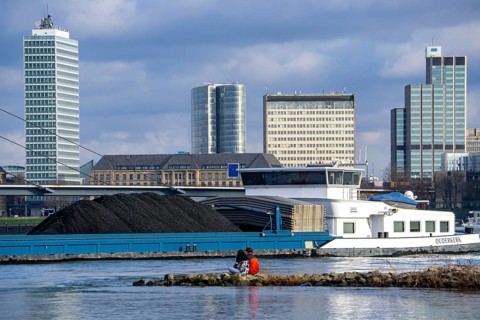 The Rhine near Düsseldorf, cargo ship, coal freighter, skyline, Rhine knee bridge, North
