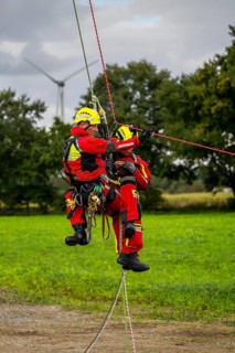 Height rescuers from the Gelsenkirchen fire brigade practise abseiling from a wind turbine from a