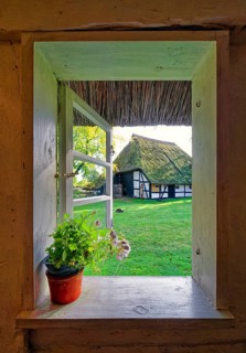 Window of a historic farmhouse with a view of another historic farmhouse, Klockenhagen Open-Air