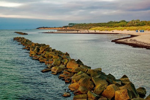 Baltic Sea beach, walkers on the Baltic Sea coast on Wustrow beach in the evening light, evening