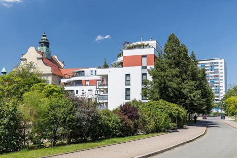 Old and new, historic craftsmen's school, modern apartment block and new building block from GDR