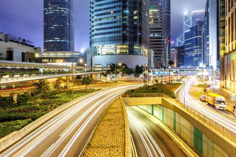 Hong Kong at night traffic with streets and skyscrapers in Hong Kong, China, Asia