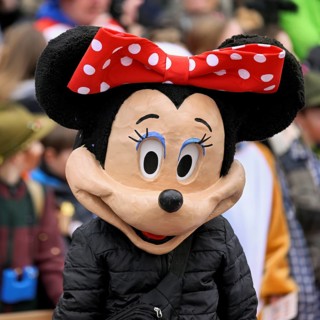 Person masked as Mickey Mouse at the carnival parade of the Wey guild on Rose Monday, Güdismäntig,