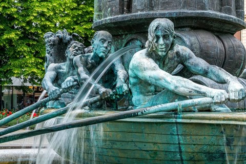 Detail of the historical column of the fountain on Josef-Görres-Platz in the historic centre of