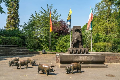 The pig fountain in the town of Zons, Dormagen, Lower Rhine, North Rhine-Westphalia, Germany,