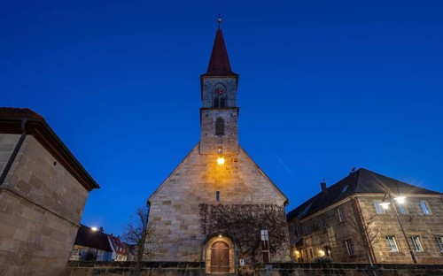 St Bartholomew's Church with poinsettia at dusk, Eschenau, Middle Franconia, Bavaria, Germany,