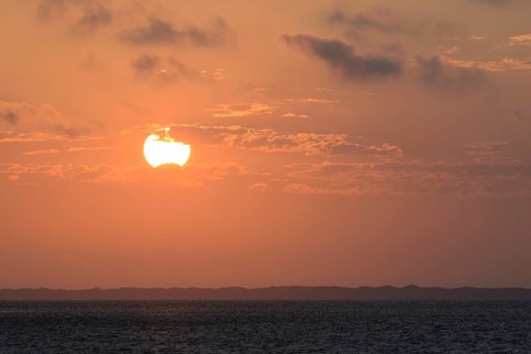 Sunset over the North Sea, on the horizon the contours of the island of Juist, Norddeich, Lower