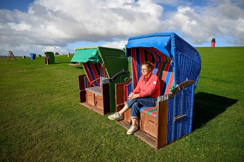 Woman in a beach chair on the island of Pellworm, Wadden Sea National Park, North Frisia, Germany,