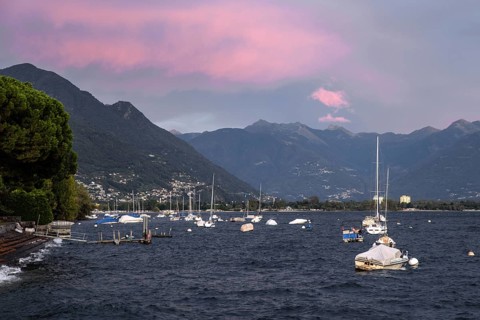 Boats lying in the water, Locarno, Lake Maggiore, clouds coloured by the evening light in the