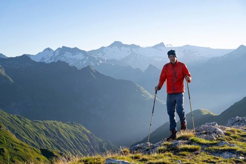 Hiker enjoying the mountain panorama in the morning, Venediger group, behind Dreiherrenkopf,