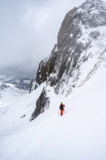 Ski tourer on a steep mountain slope, Snowy mountain landscape, Bernese Alps, Bernese Oberland,