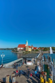Moated castle, Lake Constance, kiosk, jetty, tourists, flag, parish church of St George, onion