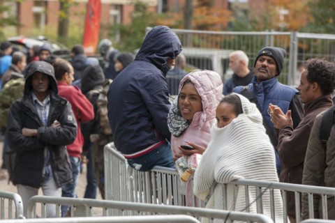 Refugees from Syria waiting to be registered at the Central Reception Centre for Asylum Seekers at