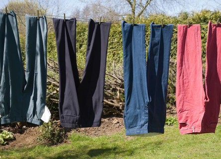 Trousers of different colours hanging from washing line, UK