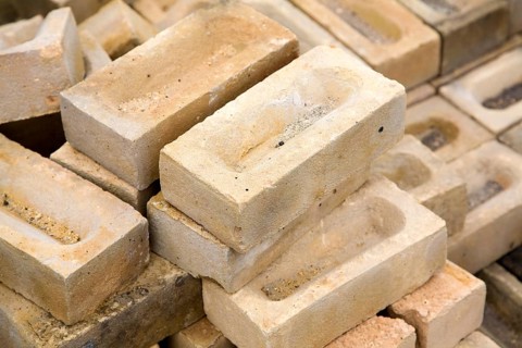 Clay bricks piled up in builder's yard, UK