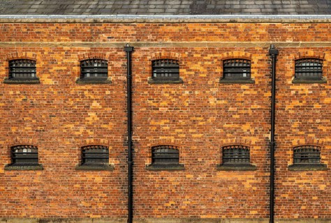 Cell windows with bars, exterior of Victorian jail museum, Lincoln Castle, city of Lincoln,