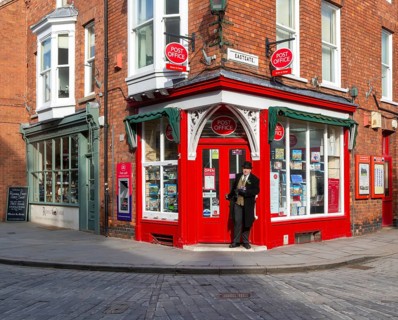 Post Office corner shop painted bright red, Eastgate, Bailgate, Uphill area of city of Lincoln,