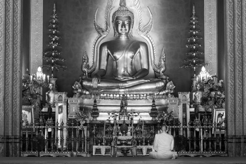 Monk meditating, Golden Buddha statue, Bhumispara-mudra, Buddha Gautama at the moment of