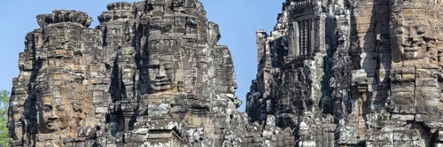 Panoramic image of giant stone-carved faces of the Bodhisattva Lokeshvara, also known as