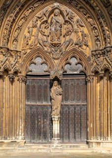 Statue of Mary and baby Jesus in doorway, The Judgement Porch, Lincoln Cathedral, Lincoln,