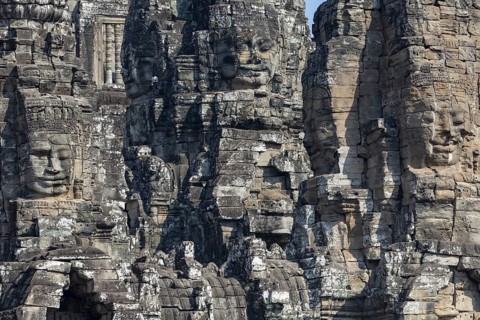 Panoramic image of giant stone-carved faces of the Bodhisattva Lokeshvara, also known as