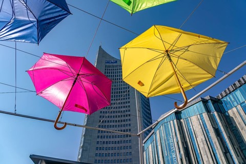 Colourful umbrellas and the MDR high-rise building MDR-Kubus on Augustusplatz, Leipzig, Saxony,