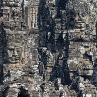 Panoramic image of giant stone-carved faces of the Bodhisattva Lokeshvara, also known as