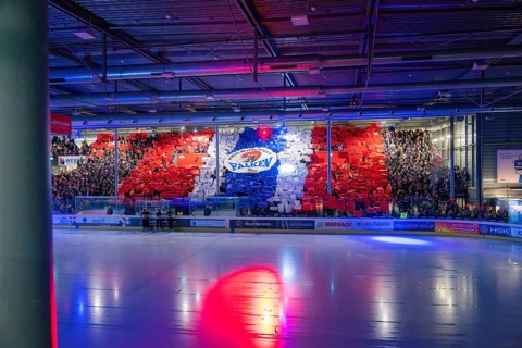 Stadium with ice hockey game and coloured stands in red, blue and white, Heilbronn Falcons vs