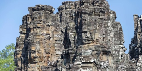 Panoramic image of giant stone-carved faces of the Bodhisattva Lokeshvara, also known as