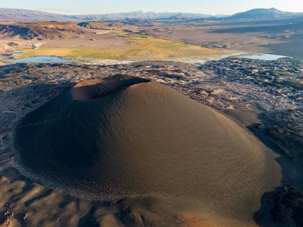 Aerial view of a large volcanic crater in the middle of a barren desert landscape, Argentina,