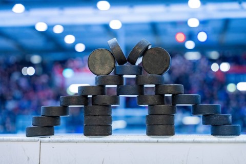 Stack of ice hockey pucks artfully arranged on the sidelines, Heilbronner Falken Vs Bietigheimer
