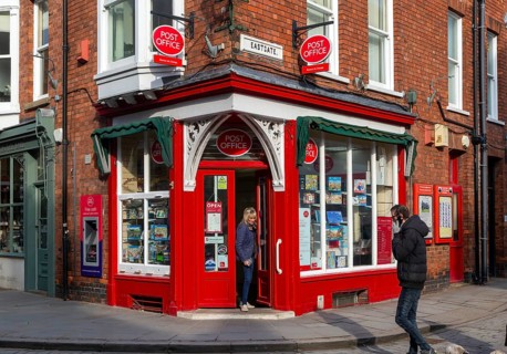 Post Office corner shop painted bright red, Eastgate, Bailgate, Uphill area of city of Lincoln,