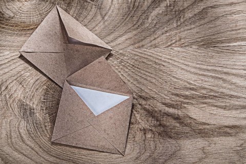 Aged post envelopes on wooden board