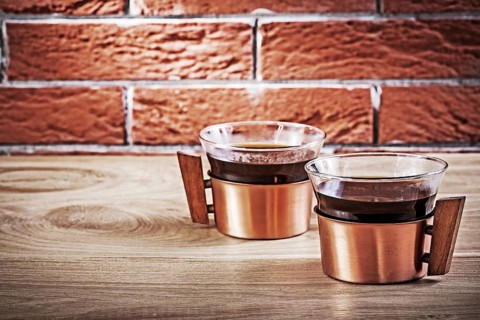 Close up cooffee in vintage copper cups on table