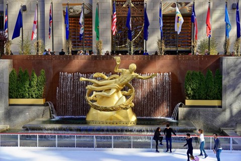 Sculpture of Prometheus in the middle of a fountain in front of an ice rink, decorated with