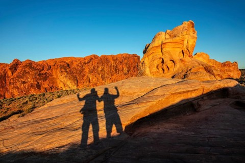 Shadows of hikers on the Fire Canyon Overlook, Valley of Fire State Park, Nevada, USA, North