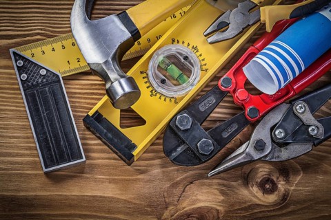 Composition of construction tools on wooden board directly above