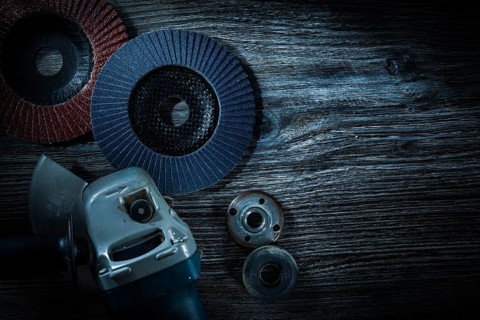 Angle grinder radial sanding discs on vintage wooden board