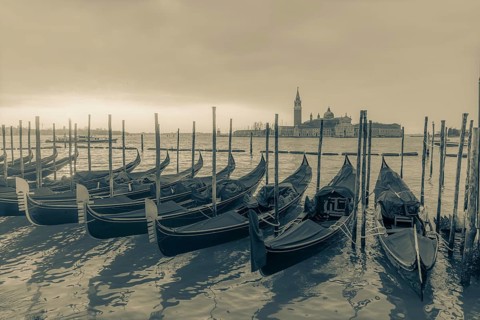 Cloudy atmosphere at sunrise, gondolas, San Giorgio Maggiore church in the background, Venice,