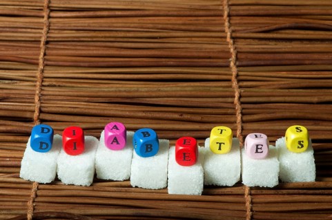 Sugar lumps and word diabetes. Multicoloured cubes