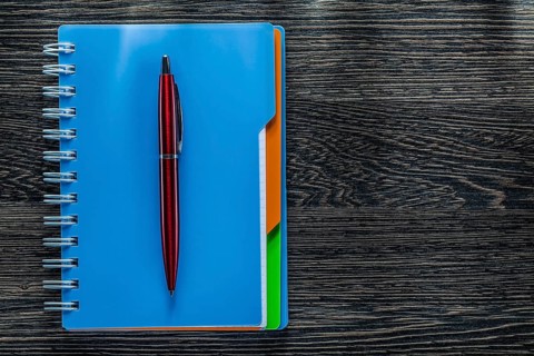 Biro pen notebook on vintage wooden board
