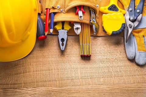 Aerial view construction tools in toolbelt hammer tapeline wrench nippers pliers cutter pencil