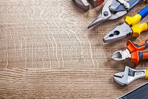 Composition of construction tools on wooden board copy space
