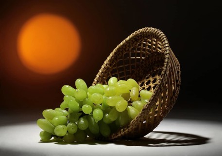 Green grapes, citrus paradisi in a cane basket, India, Asia