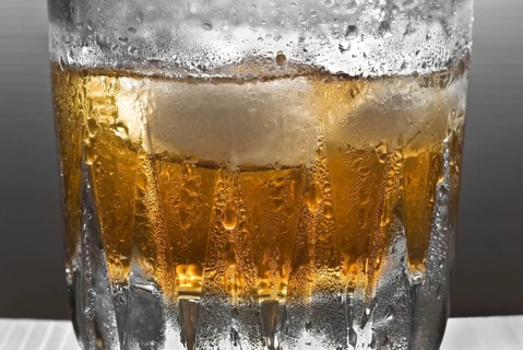 Drinks, shimmering glass of whisky with ice