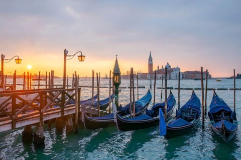 Cloudy atmosphere at sunrise, gondolas, San Giorgio Maggiore church in the background, Venice,