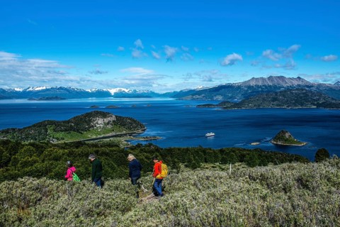 Hikers and cruise ship Ventus Australis in Wulaia Bay, Beagle Street, Ushuaia, Tierra del Fuego,