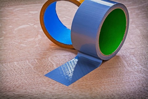 Close up of duct tapes on vintage brown wooden board maintenance concept